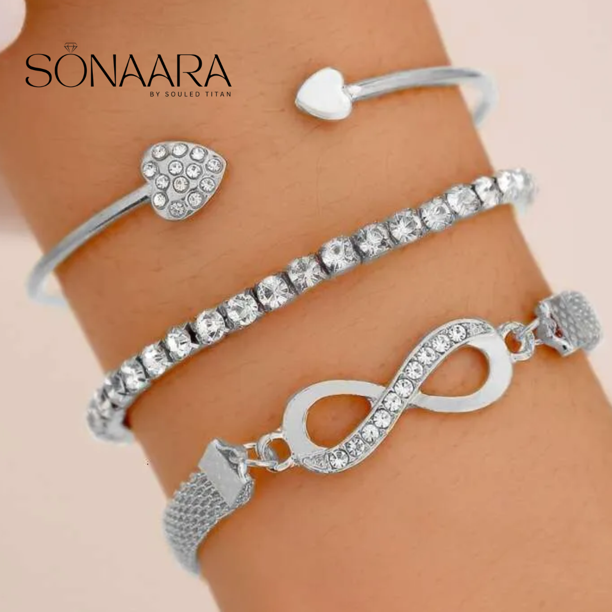 Silver bracelets with heart and infinity designs on a wrist, branded 'Sonaara'.
