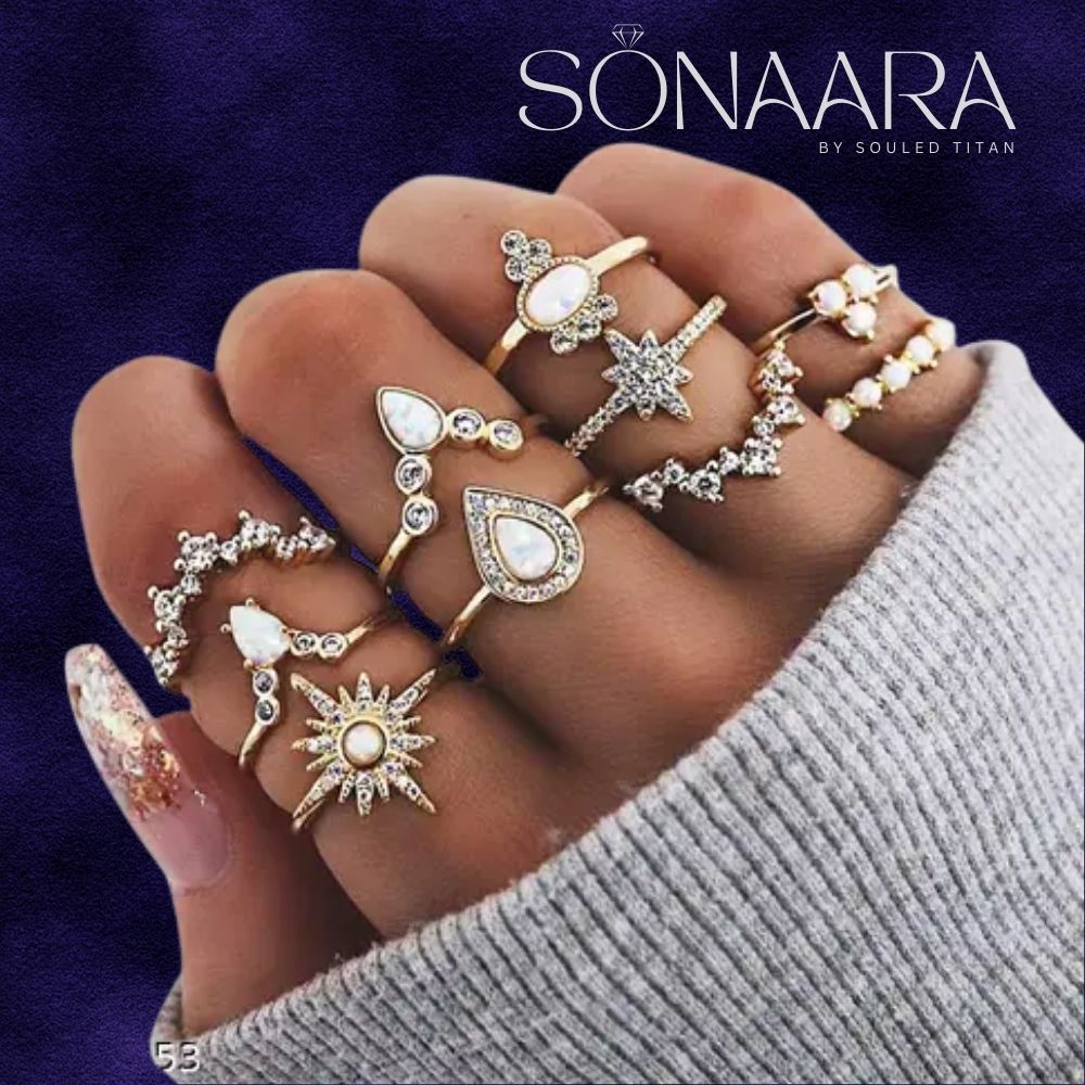 Hand wearing stackable rings with various designs on a dark background, featuring the brand 'Sonaara'.