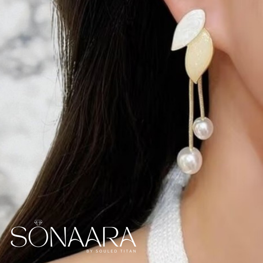Pearl drop earring worn by a woman with 'Sonaara' branding.