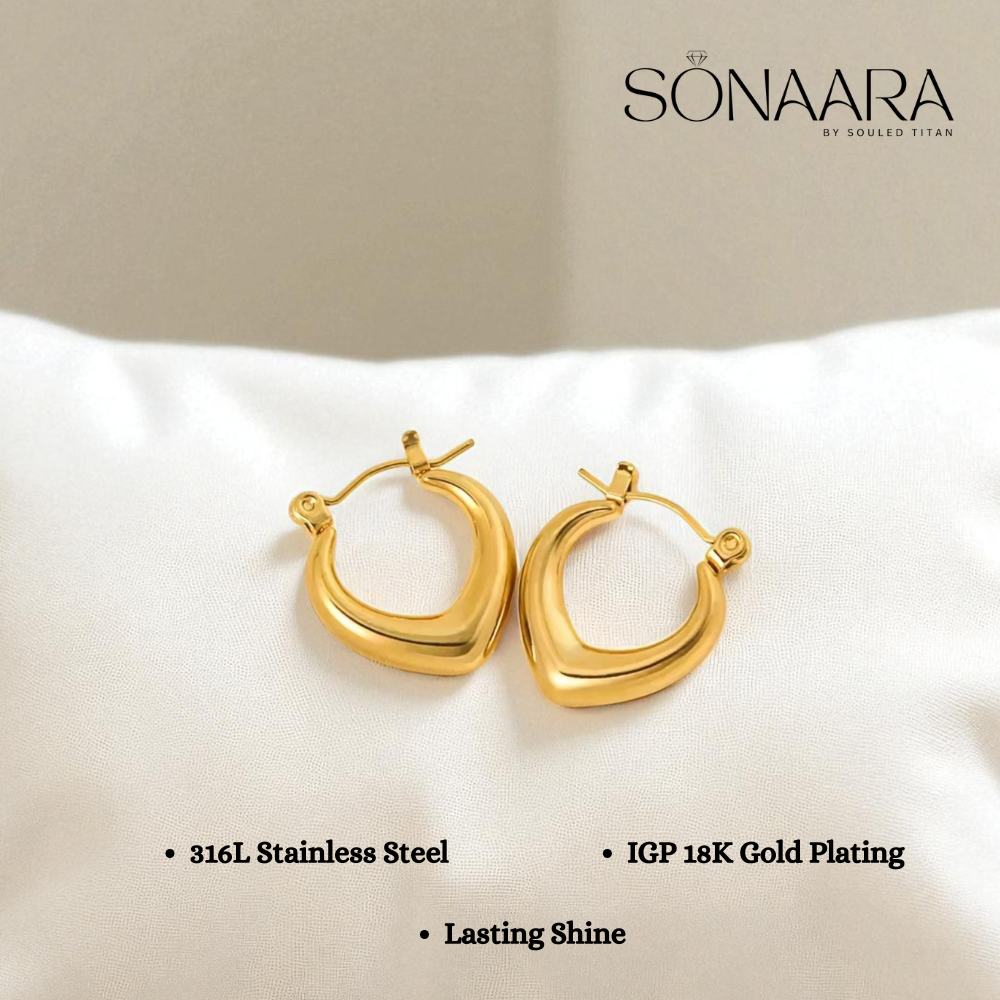 Gold hoop earrings on a white cushion with Sonaara branding.