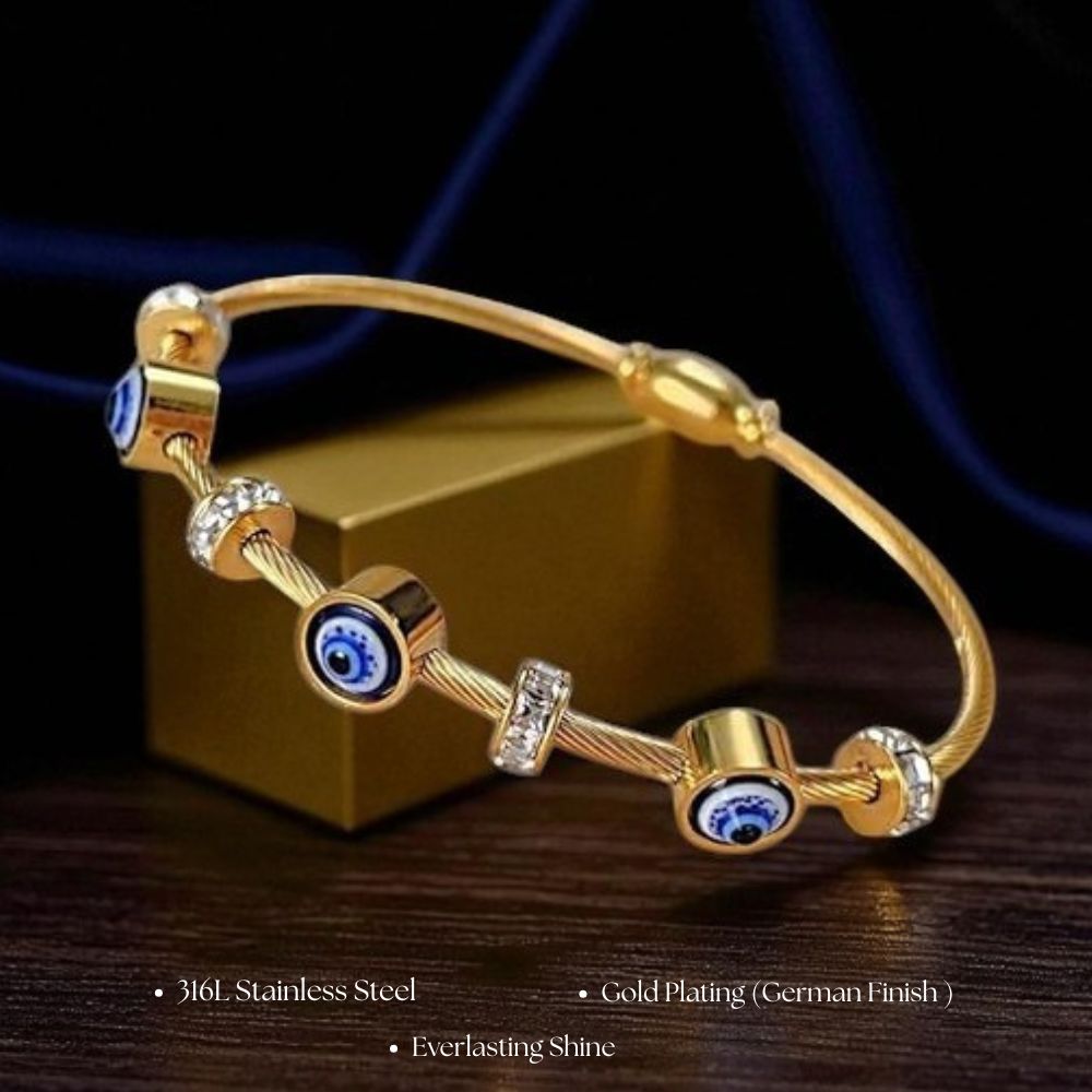 Gold bracelet with blue stones and evil eye crystals on a dark background