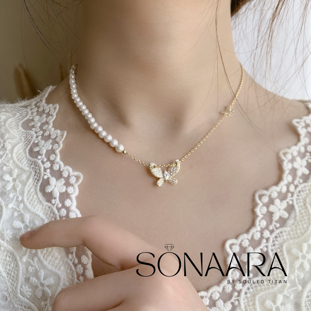 Pearl Butterfly Stainless Steel necklace with a butterfly pendant worn by a Girl on a lace garment, branded 'Sonaara'.