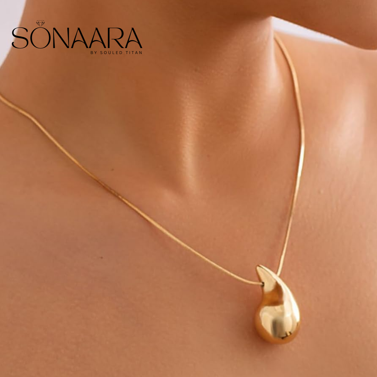Gold necklace with a teardrop pendant on a mannequin, branded 'Sonaara'.