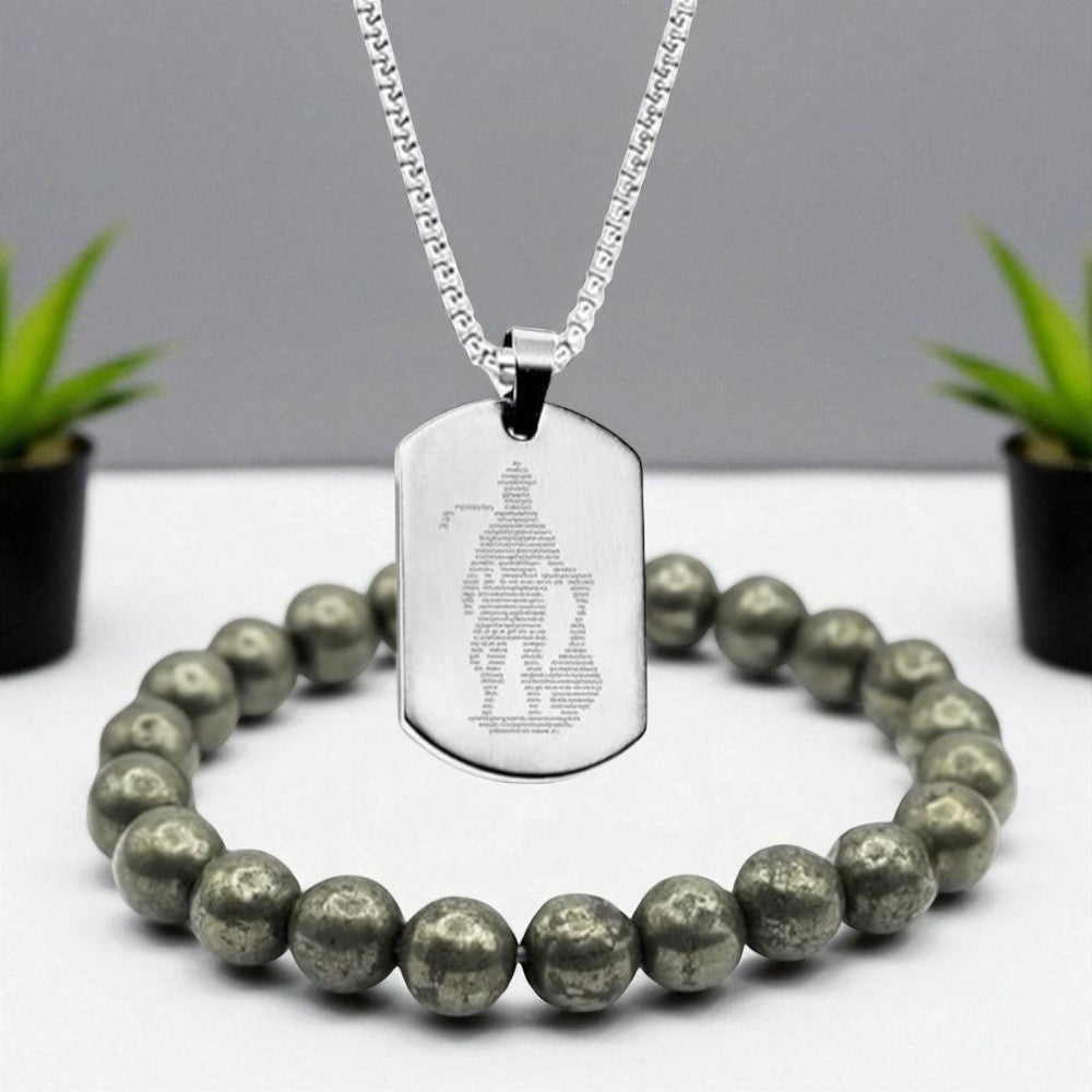 Silver Hanuman Chalisa necklace with engraved Hanuman Chalisa on a white surface with green plants in the background and Raw pyrite