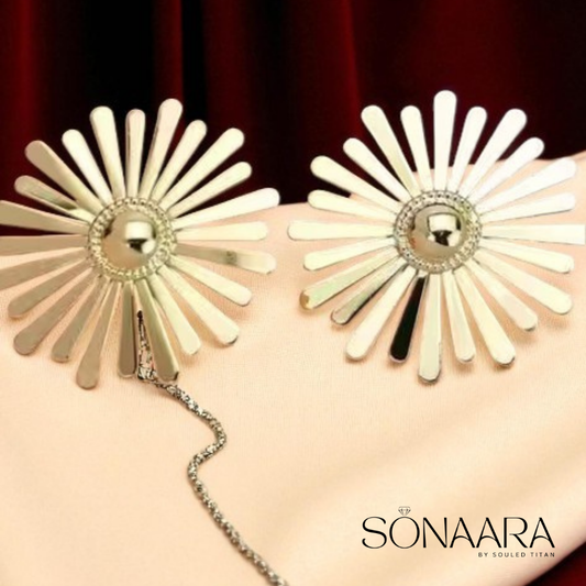 Gold Plated flower shaped earrings on a  beige colour suede cloth