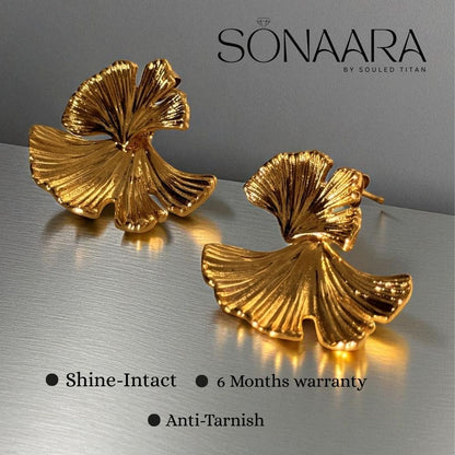 Inforgraphics for Gold leaf-shaped earrings on a reflective surface with 'Sonaara' branding.