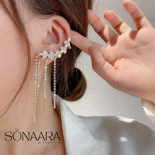 Tassel drop earring being worn with hand holding hair, Sonaara brand visible