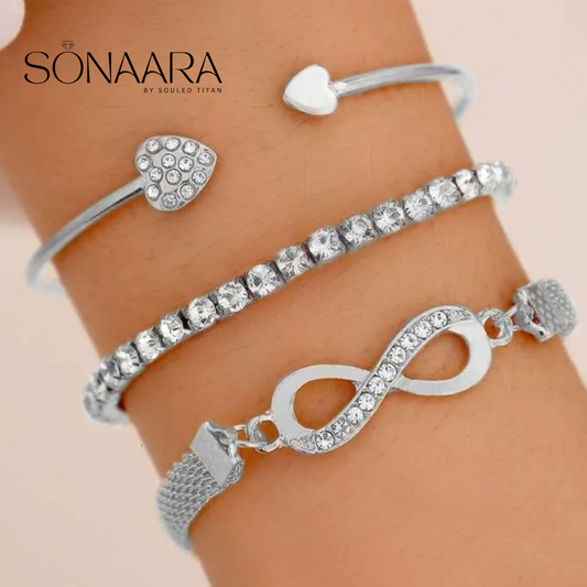 Silver bracelets with heart and infinity designs on a wrist, branded 'Sonaara'.