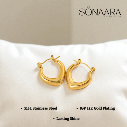 Gold hoop earrings on a white cushion with Sonaara branding.