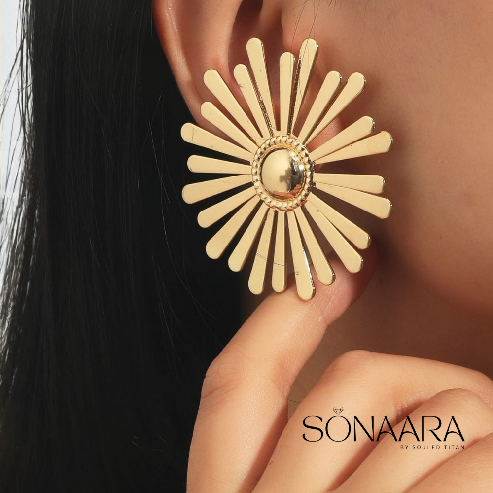 Gold plated earrings worn by a woman