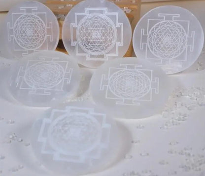 Set of six translucent selenite plate with Shree Yantra designed on a light background