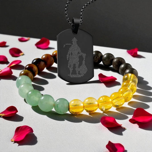 Black pendant, beaded bracelets, and rose petals on a gray surface