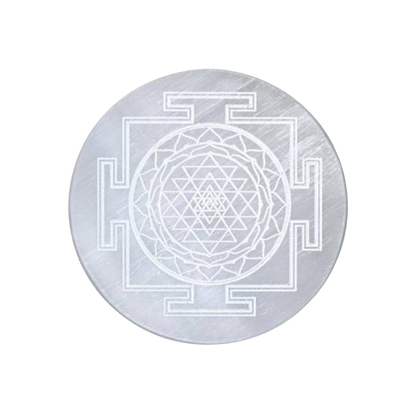 Circular Selenite plate with Sri Yantra design on a white background