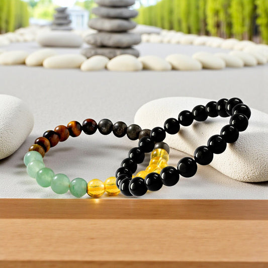 Set of Money magnet and black tourmaline bracelets on a stone surface with a natural background
